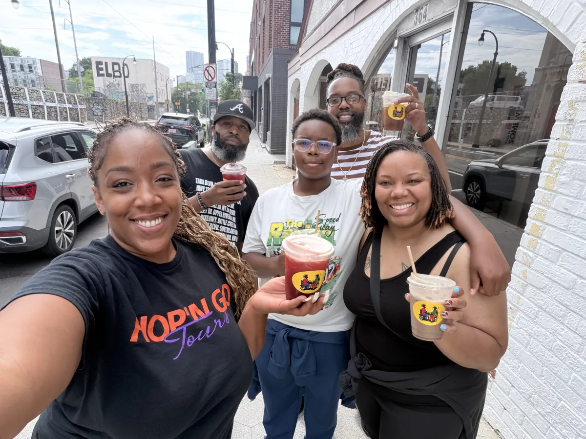 Tour host and guests with drinks on the street